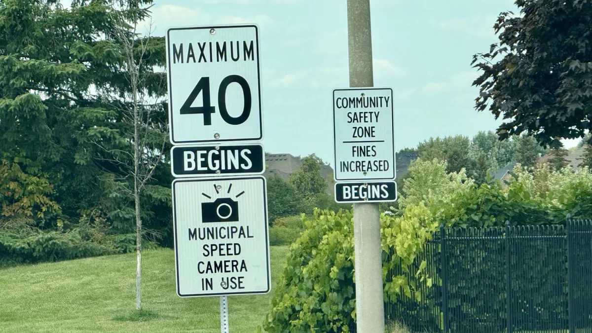 Traffic sign saying "Municipal Speed Camera in use"